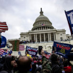 Protestors storming the captiol in an act of civil unrest, insurection