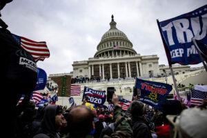 Protestors storming the captiol in an act of civil unrest, insurection