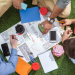 overhead view of business people working on a crisis management plan outside