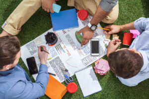 overhead view of business people working on a crisis management plan outside