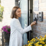 Woman unlocking a door with a key card - The best Business Security Systems for Property Managers