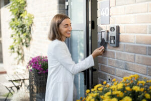 Woman unlocking a door with a key card - The best Business Security Systems for Property Managers