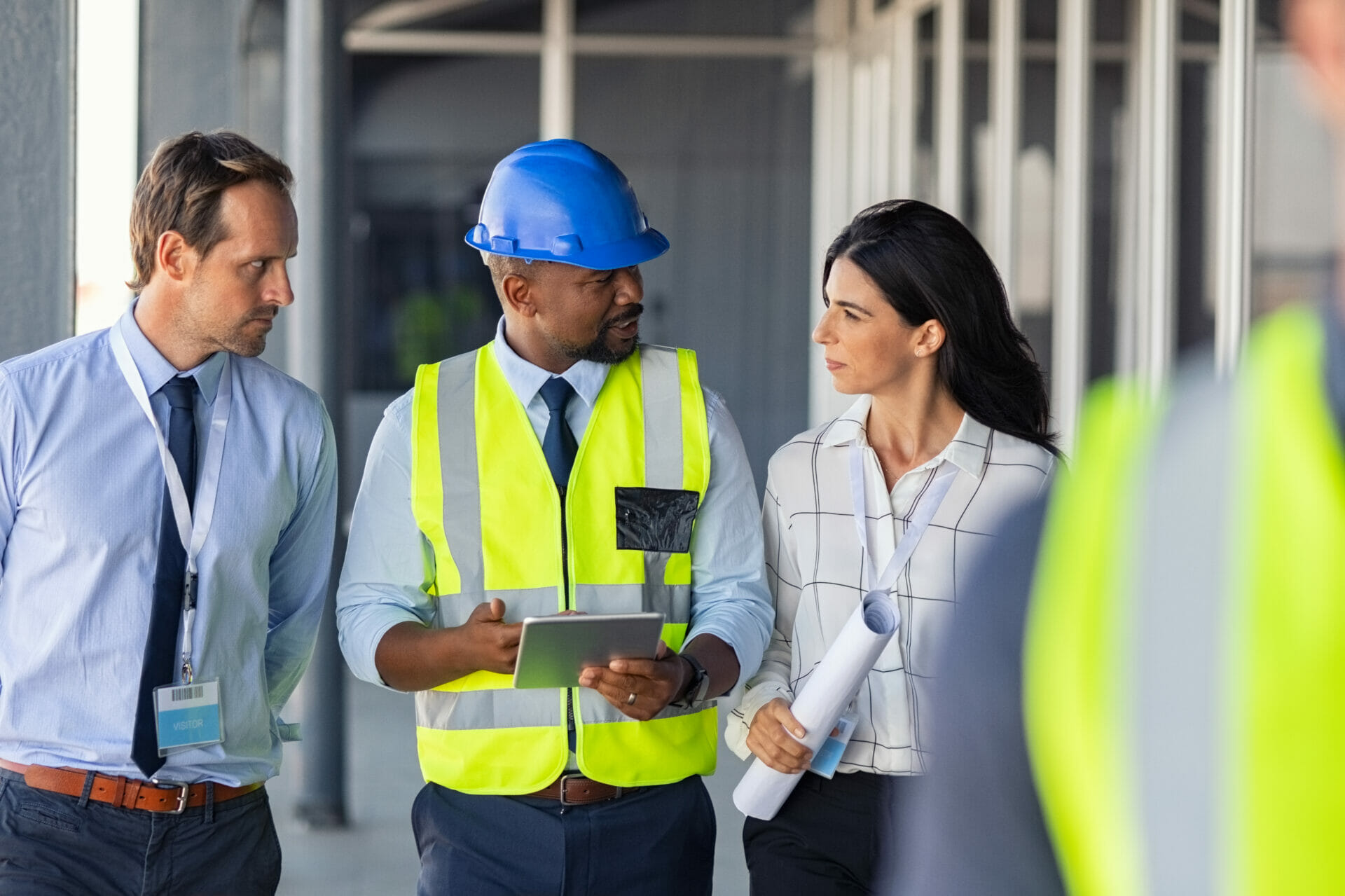 An engineer and the safety team walking a construction site discussing risk awareness
