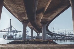 Securing Infrastructure - A view from under a bridge looking out towards the shipping yard.