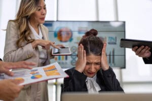 Image of a stressed business owner with her head in her hands to reresent business continuity and crisis management